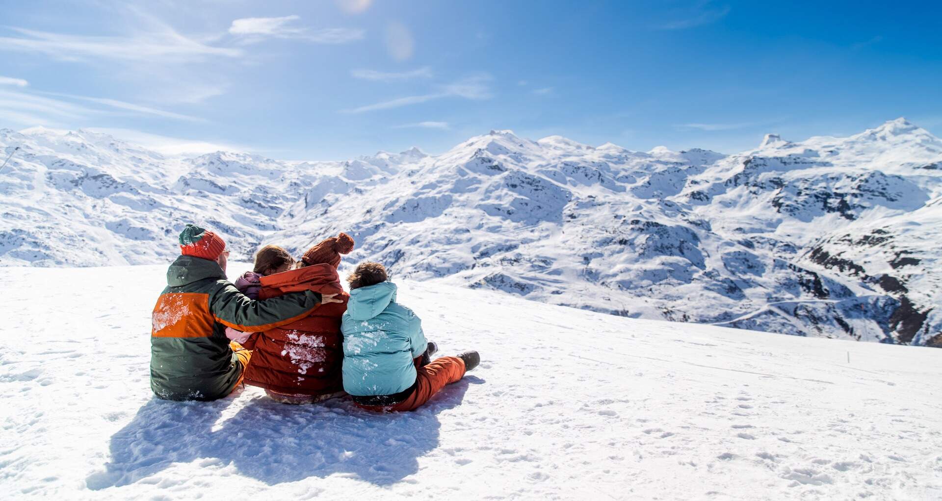 Family watching the mountains after booking a ski holiday with Sunwebs Early booking deals