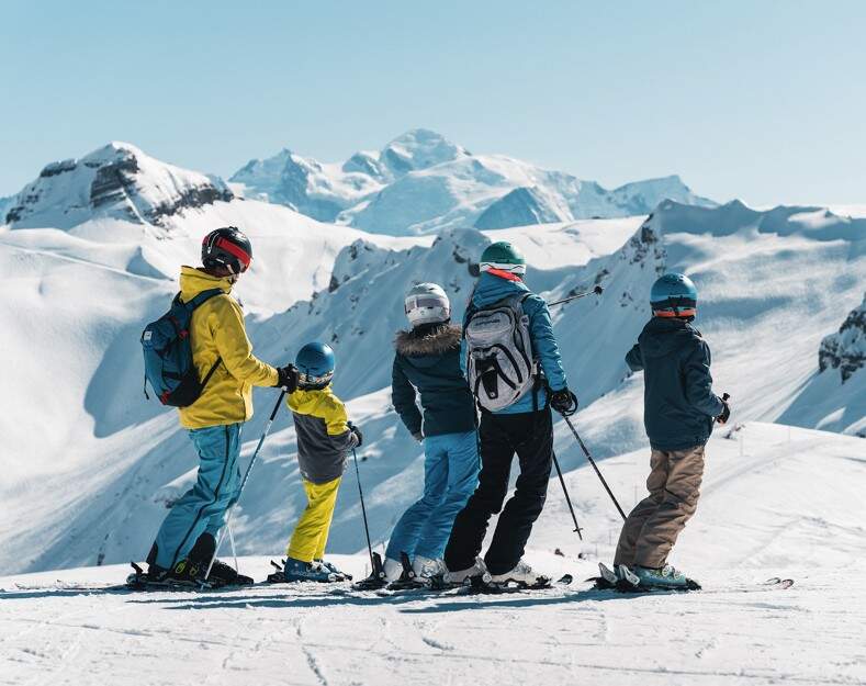 Family overlooking the snowy mountain tops